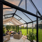 Interior of The Cottage glass greenhouse with couch and plants