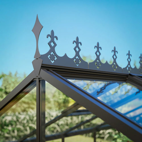 Decorative roof ridge cresting along the roofline of a glass greenhouse