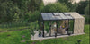 Premium glass garden greenhouse in a backyard with people relaxing inside on sofas and chairs, showcasing a luxury outdoor living space, durable greenhouse design, and year-round gardening.
